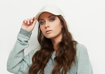 Image showing Fashion, portrait and woman with a cap in studio with attitude, confidence or casual style on white background. Trendy, face and female model in cool, edgy or streetwear clothes or outfit choice