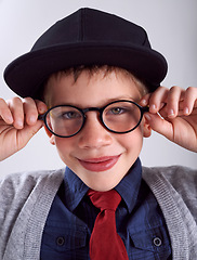 Image showing Glasses, smile and portrait of child in studio for eye care, vision and optical health. Happy, optometry and cute young boy kid with stylish eyewear or spectacles isolated by gray background.