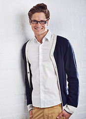 Image showing Fashion, glasses and portrait of happy man with confidence, smile or positive attitude on wall background. Style, face and casual male person in comfortable clothing, good mood or cool outfit choice