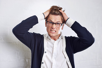 Image showing Business, stress and portrait of man with hands in hair for crisis, disaster or panic on wall background. Angry, face and overthinking male entrepreneur with startup risk, fail or bankruptcy anxiety