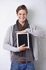 Image showing Happy man, portrait and tablet screen for advertising or marketing on a white studio background. Face of young male person with smile and technology display in casual fashion for app or mockup space