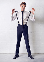 Image showing Man, portrait and fashion with comedy, confidence and suit with trendy and stylish clothes. Hipster, male person and wall with event, classic and fancy suspenders with dressing formal for celebration