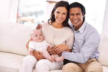 Image showing Happy family, portrait and baby on sofa for bonding, holiday weekend or support together at home. Father and mother smile with young little child, kid or newborn toddler on living room couch at house