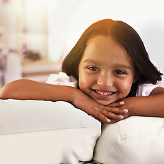Image showing Home, relax and portrait of child on sofa for playful, fun and resting on weekend in living room. Happy, childhood and face of young girl alone on couch for chilling, comfort and smile in Brazil