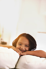 Image showing Happy, morning and portrait of child on sofa for playful, fun and resting on weekend in living room. Smile, childhood and face of young girl alone on couch for relaxing, holiday and comfort in home