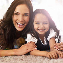 Image showing Happy mother, portrait and little girl lying on floor in relax for bonding, love or care together at home. Face of mom, parent and child, daughter or kid with smile in living room for family time