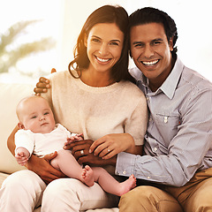 Image showing Happy family, portrait and baby for support, love or care on holiday or bonding together at home. Father and mother smile with young little child, kid or newborn toddler on living room couch at house