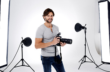 Image showing Photographer, portrait and smile with camera in studio for career, behind the scenes and backpack. Photography, person or happy with equipment, mockup space or shooting gear for photoshoot or passion