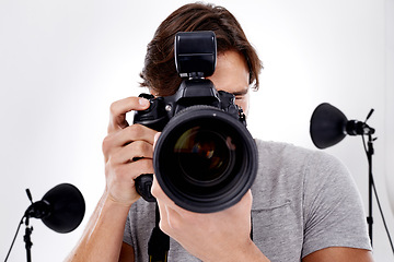 Image showing Man, camera lens and photography with technology in studio, press or media for news on white background. Photographer, photo journalist and creative with paparazzi, equipment or gadget with closeup