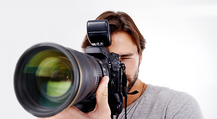 Image showing Man, camera lens and photographer with technology in studio, press or media for news on white background. Photography, photo journalist and creative with paparazzi, equipment and closeup in studio