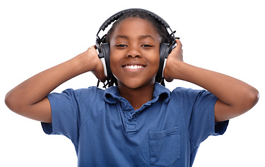 Image showing Child, music and smile with portrait and headphones with audio in a studio. Happy, fun listening and streaming radio of African male boy with casual fashion and podcast sound by a white background