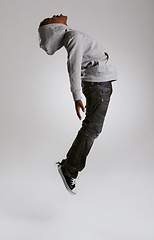 Image showing Teen, fashion and jump with energy in studio with kid in streetwear hoodie on grey background. African, child and cool boy in the air with casual style, clothes and comfortable outfit in mockup