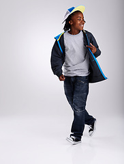 Image showing African boy, talent and dancing for fashion in studio for hiphop in backdrop of white background. Child, funky and happiness with smile of youth for kids clothes and mockup space with stylish person