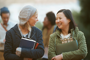 Image showing Students, women and friends outdoor on campus for university, conversation and walking to class with smile. College, communication and books for studying, education and academic growth with talk