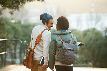 Image showing College students, couple and walk in sunset, campus and bags for class and notebooks. Man, woman and smile for university, homework and cozy in winter season to study, embrace and date for academic