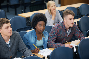 Image showing College, writing and students learning with notes in class, auditorium or lecture hall for education. University, classroom or people in campus for knowledge or studying a course in academy or school