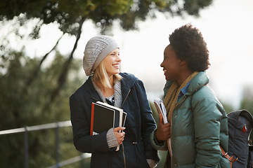 Image showing Women, university student and friends with book on campus for sharing, information and notes on research. Classmates, campus and knowledge with advice to prepare for assignment submissions.