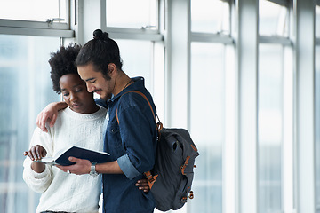 Image showing Couple, university and students with a book, hug and conversation for project and teamwork. College, man and woman with ideas or brainstorming with planning and education with embrace or knowledge