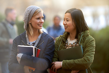 Image showing School, books and conversation with woman friends outdoor on campus together for learning or development. College, education or university with young student and best friend talking at recess break