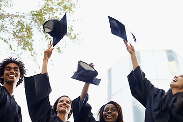 Image showing Happy people, students and hats in celebration for graduation, winning or achievement at campus. Group of graduates throwing caps in air for certificate, education or milestone at outdoor university