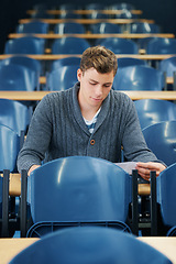 Image showing Lecture hall, college and man with thinking, student and knowledge with exam and education. Person, writing and guy in classroom with test and learning with studying and creativity with research