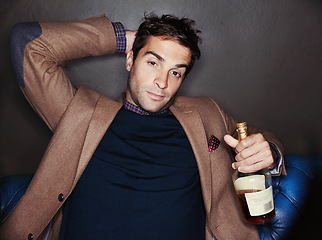 Image showing Portrait, night and man in a club, alcohol and relax with event and confident guy with weekend break. Face, bottle and fashion with person and luxury with birthday celebration and expensive party