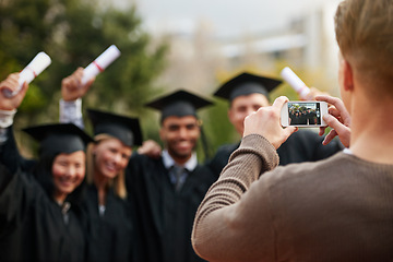 Image showing Graduation, certificate and photograph of student friends outdoor on campus at university or college. Education, hands and success with group of young graduate people cheering together for picture