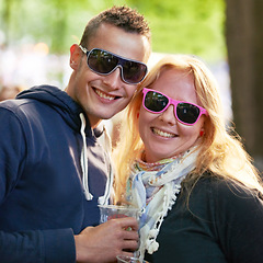 Image showing Portrait, hug and couple with sunglasses, music festival and romance with sunshine and weekend break. Face, people and embrace with woman and man with summer and bonding together with funky eyewear