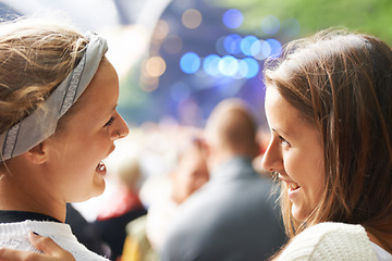 Image showing Happy, friends and women at music festival, concert or party for social life, excited and talking of rave or techno. People, audience or crowd from back at a carnival, event and bokeh on a stage