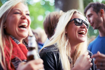 Image showing Happy, drinks and women at music festival, concert or party laughing, excited and enjoy outdoor rave or techno celebration. Young friends, audience or crowd with beer bottle or alcohol for holiday