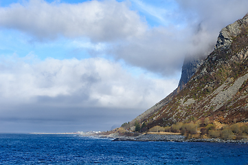 Image showing Majestic cliffside by the ocean with cloud-covered mountain peak