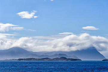 Image showing Majestic coastal landscape with cloud-covered mountains and sere