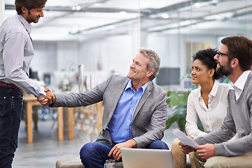 Image showing Business people, handshake and meeting with team for agreement, partnership or b2b at office. Businessman or employees shaking hands for greeting, deal or collaboration in discussion at workplace