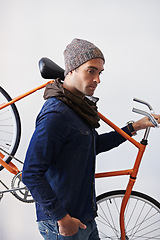 Image showing Bicycle, walking and man in building carrying bike for healthy and eco friendly transportation for travel. White background, thinking and cyclist with hipster and journey for carbon neutral commute