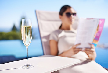 Image showing Relax, pool and woman with champagne, magazine and reading in lounge chair on business trip. Travel, hospitality and businesswoman on deck with wine, book and sunshine holiday at luxury villa hotel