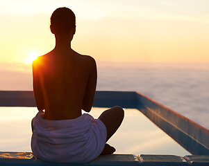Image showing Back, yoga and meditation of woman at sunset by swimming pool for healthy body, wellness and zen outdoor on mockup space. Rear view, mindfulness or person by water at twilight to relax, peace or calm