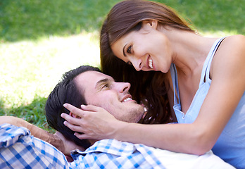 Image showing Man, woman and relax in park for holiday in summer bonding or weekend, happiness or outdoor. Happy couple, smile and embrace on blanket on grass lawn for dating connection or rest, love or London