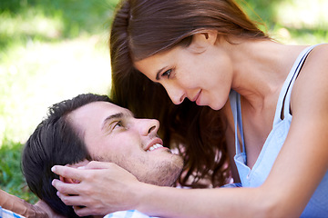 Image showing Couple, smile and picnic on grass with embrace for bonding, love and sunshine in park outdoors. Happy, man and woman in love with intimacy for connection, romance and healthy relationship together