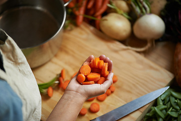 Image showing Vegetables, hands and person with carrot and wooden board for cooking lunch and nutrition diet at home. Wellness, health and organic food with meal, vegetarian and ingredients for salad in a kitchen