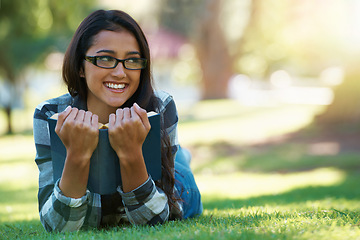 Image showing Happy woman, student and relax with book in nature for literature, studying or story on green grass. Young nerd, geek or female person with smile and glasses for chapter, learning or outdoor reading