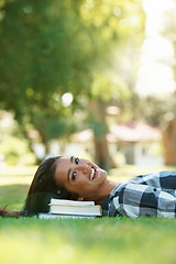 Image showing Books, student and portrait of woman in park for studying, learning or reading outdoors. Education, knowledge and happy person with textbooks relax, rest and smile on grass for university or college