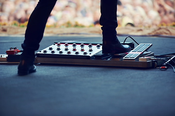 Image showing Artist, stage and feet on equipment of instrument at concert, music festival or live event in Amsterdam. Performer, boots and pedal on platform for electric guitar for crowd, people and community