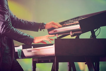Image showing Musician, keyboard synthesizer and hands at stage playing at concert, music festival or live event in Amsterdam. Artist, performance and amplifier at outdoor party for fun, enjoyment and celebration