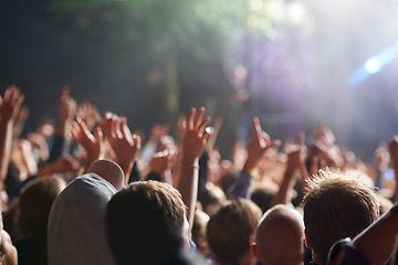 Image showing Hands, people and crowd at music festival with dancing for rock party at concert with stage lights, nightclub or dj. Group, entertainment and holiday techno in summer for new years, adventure or rave