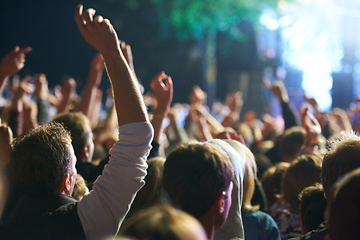 Image showing Hands, people and music festival with dancing for party at concert with stage lights, nightclub or dj. Crowd, nature and entertainment for holiday techno in summer for new years, adventure or rave