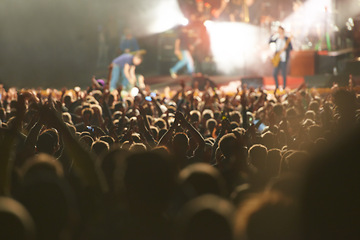 Image showing Crowd, live concert and stage with dancing audience as music festival for entertainment, performance or carnival. People, hands and fans of musicians with lighting for rock event, rave or vacation