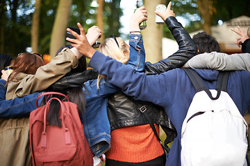 Image showing Backpack, outdoor and hug with friends, music festival or excited with happiness or nature. Park, rear view or people with fun or event with party on holiday or vacation with getaway trip or cheering