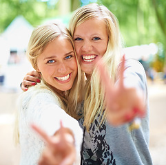Image showing Peace hands, portrait and women friends hug in a park with freedom, fun and bonding in nature together. V sign, face and people embrace in a forest for travel, vacation or weekend reunion outdoor