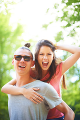 Image showing Portrait, piggyback and happy couple in a park with fun, freedom and celebration outdoor. Energy, love or face of excited people in forest for weekend, holiday or vacation, bonding in nature together
