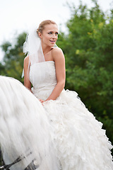 Image showing Wedding, woman and riding with horse outdoor or happiness for celebration, marriage and confidence in countryside. Bride, person and stallion on lawn in field with smile, dress and animal at ceremony